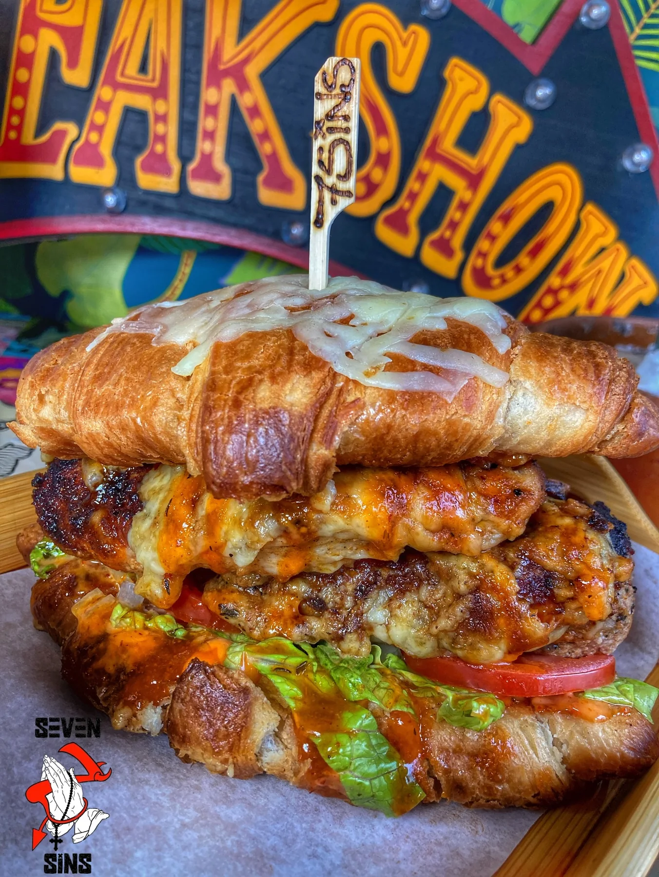 A croissant burger stacked with fillings
