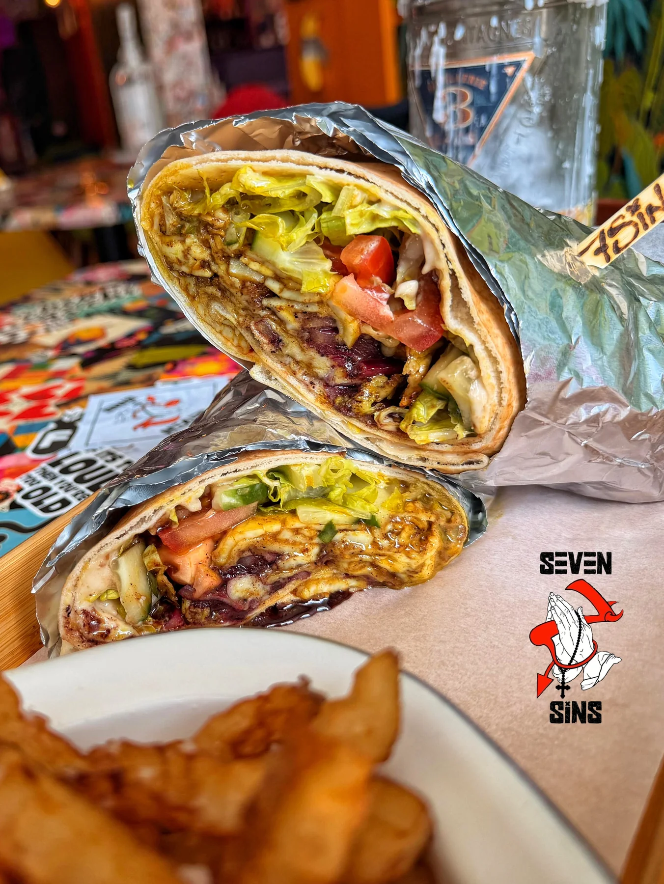 A loaded wrap with fries at Seven Sins